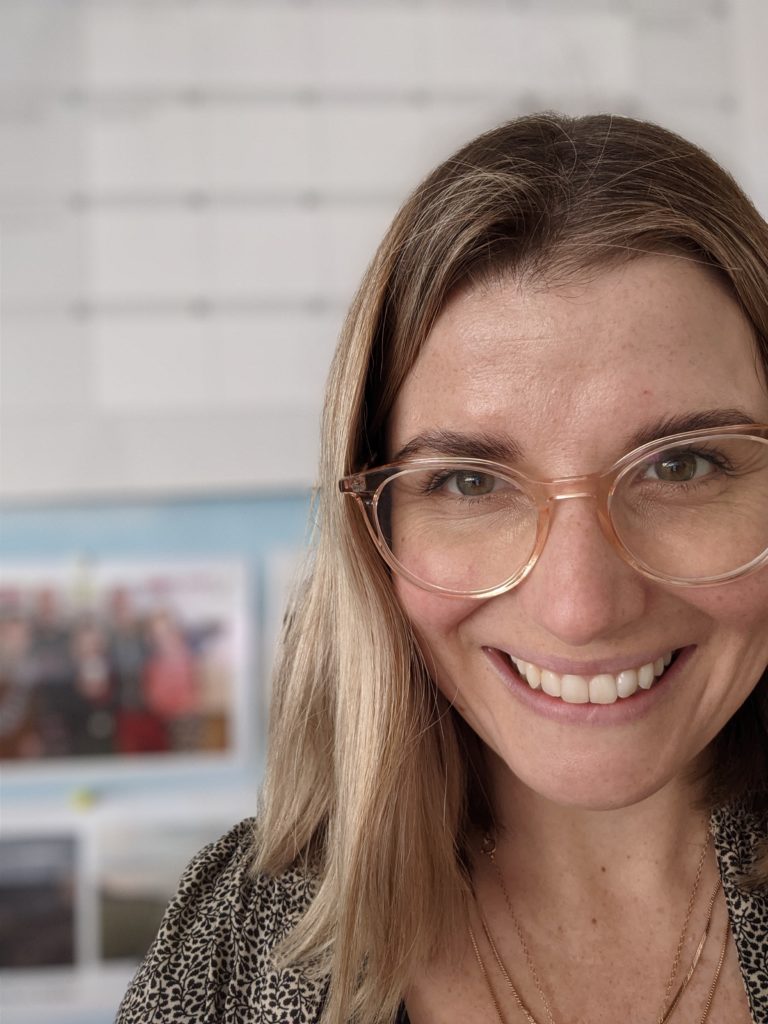 The author. Light brown hair, glasses smiling