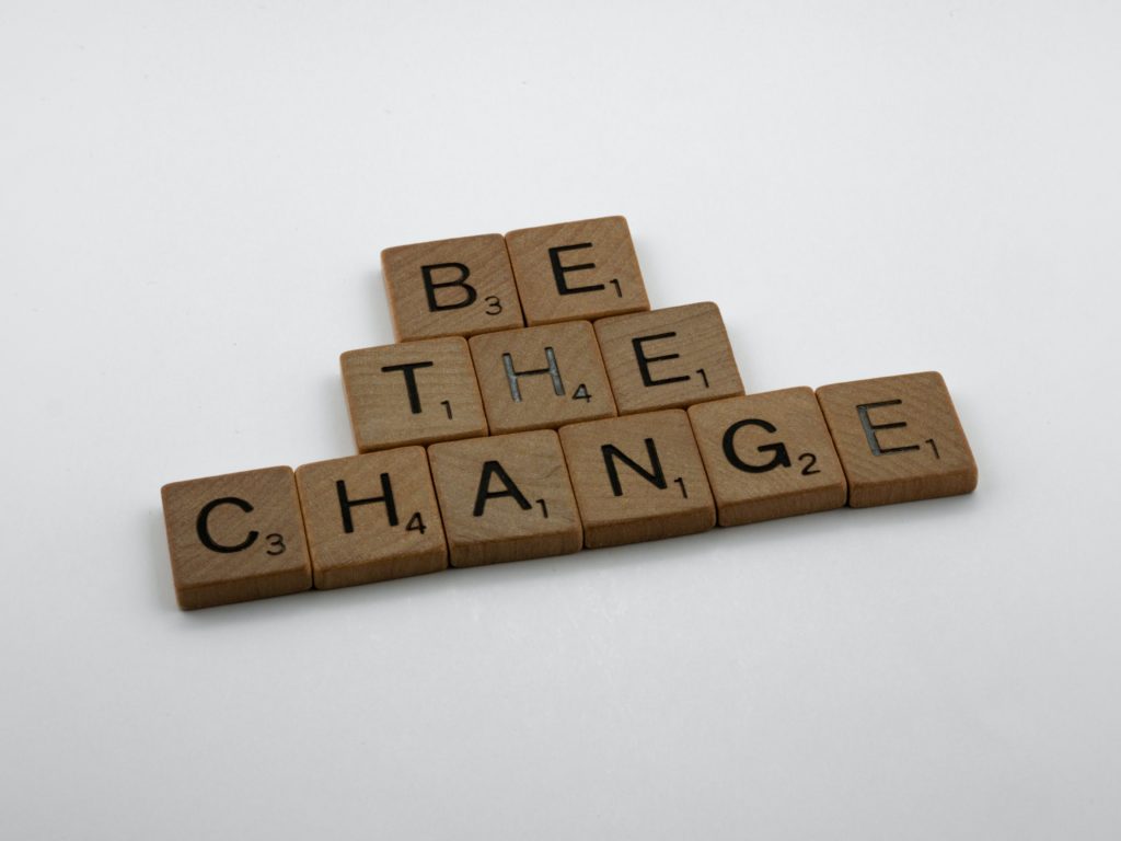 scrabble tiles spell out be the change