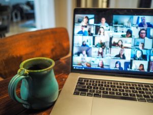 open laptop displaying a zoom video conferencing meeting