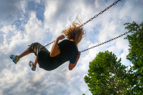 A photo of a person on a swing