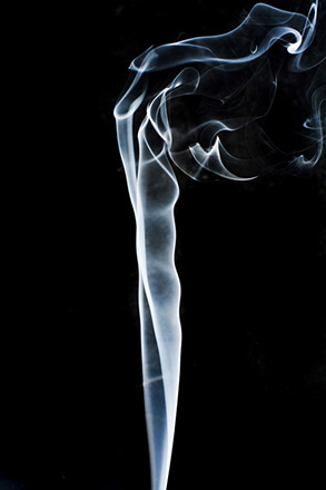 Figure is a photo of smoke that rises smoothly at the bottom and forms swirls and eddies at the top.
