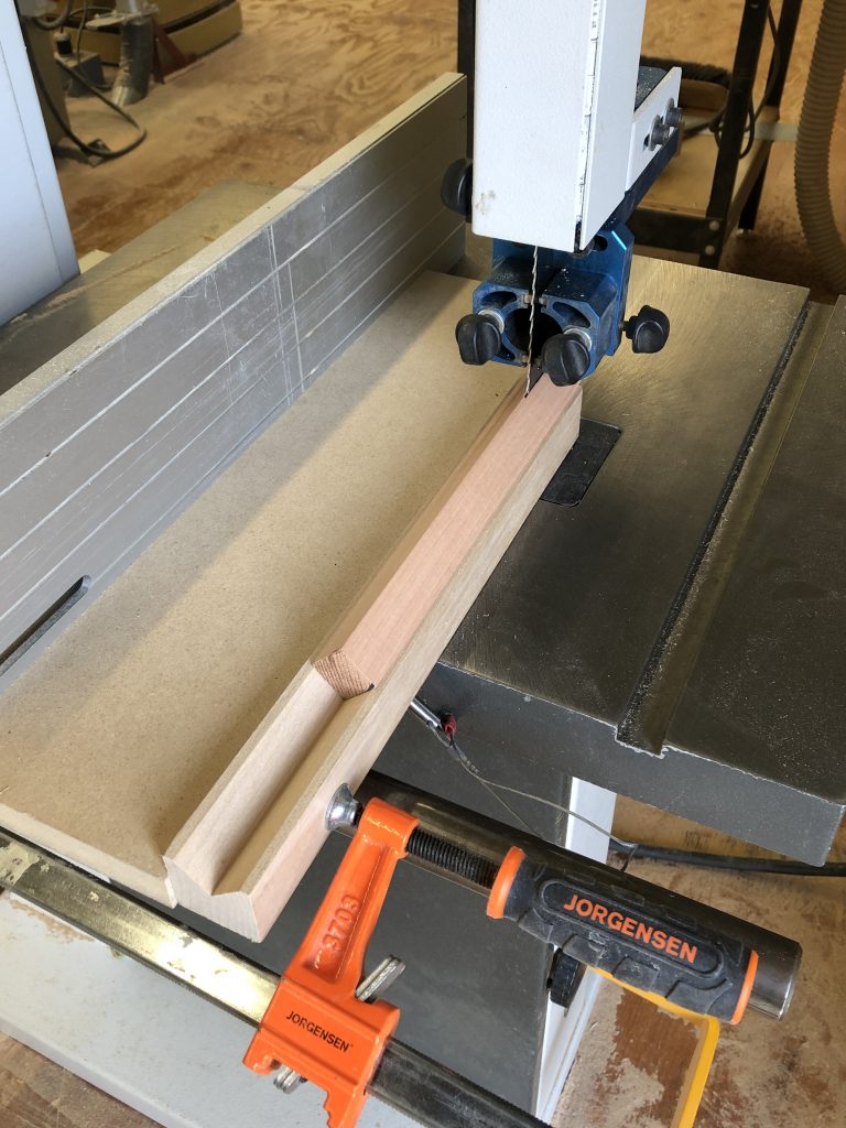 Square stock being cut in a V block