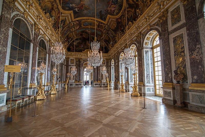 A contemporary photograph of the Hall of Mirrors in the Palace of Versailles, a spectacular example of baroque architecture and interior design.