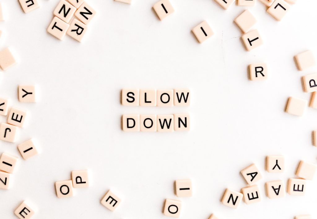 Individuals letter blocks places together to spell the phrase slow down